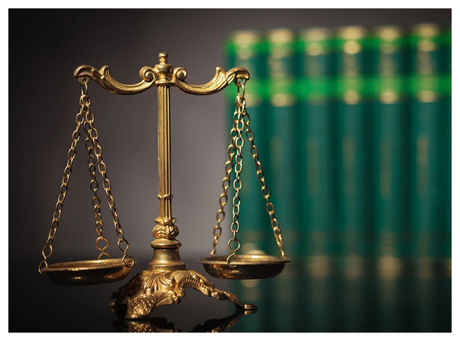 A close up of the scales of justice on top of a table