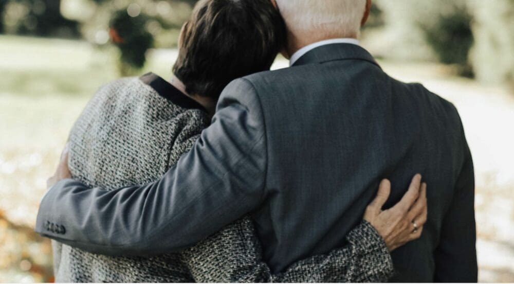 A man and woman hugging each other.