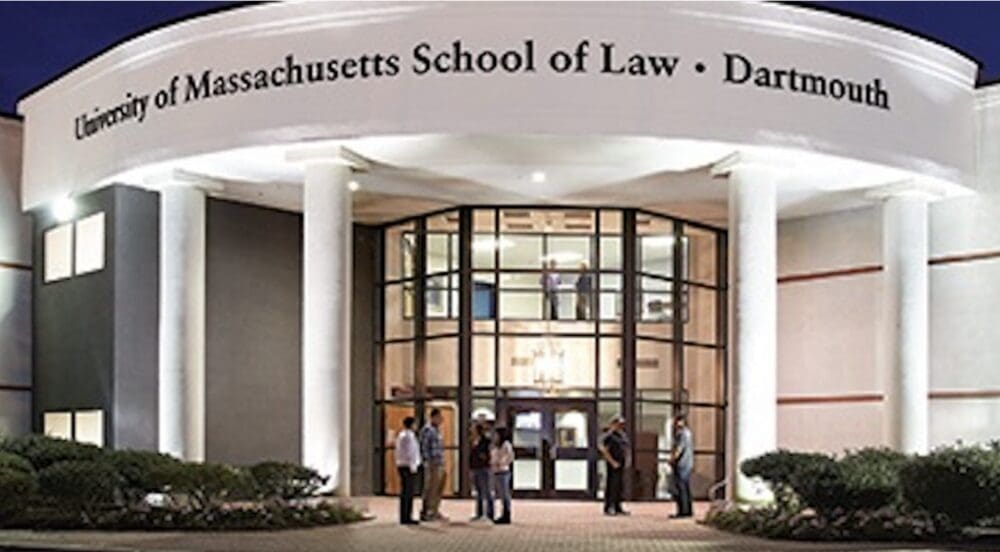 A group of people standing outside of the massachusetts school of law.