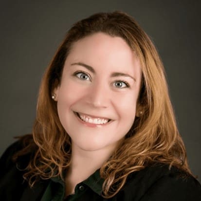 Smiling woman with brown hair and green shirt.