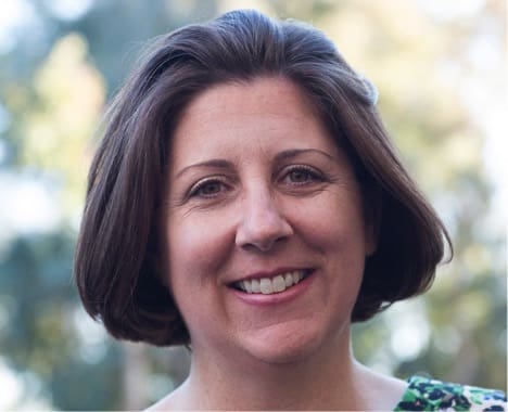 Smiling woman with short brown hair.