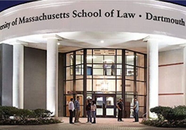 A group of people standing outside of the massachusetts school of law.